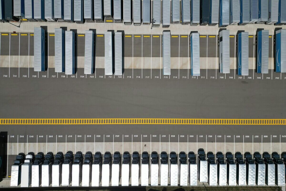 Trucks stopped in a parking lot due to logistics issues, causing a supply chain disruption