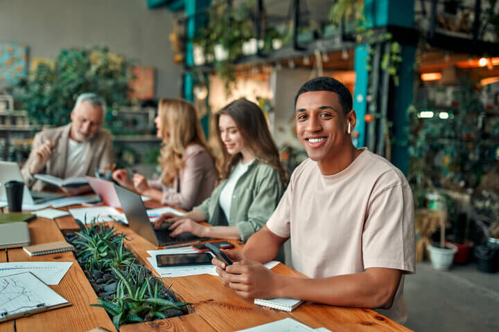 Close up of young male accountant in casual office setting