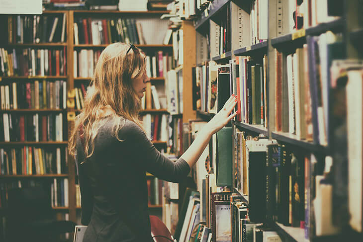 Woman Browsing Books Library